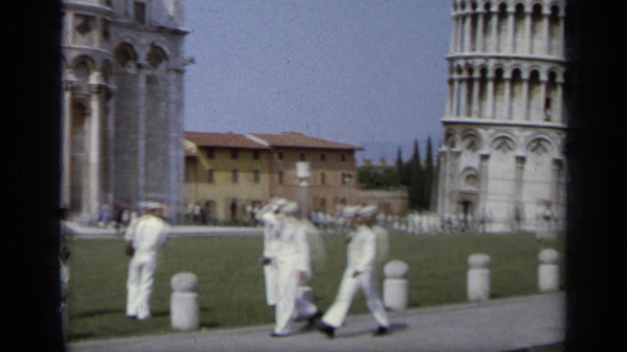 Marines photographing the Leaning Tower of Pisa beside the lawn.