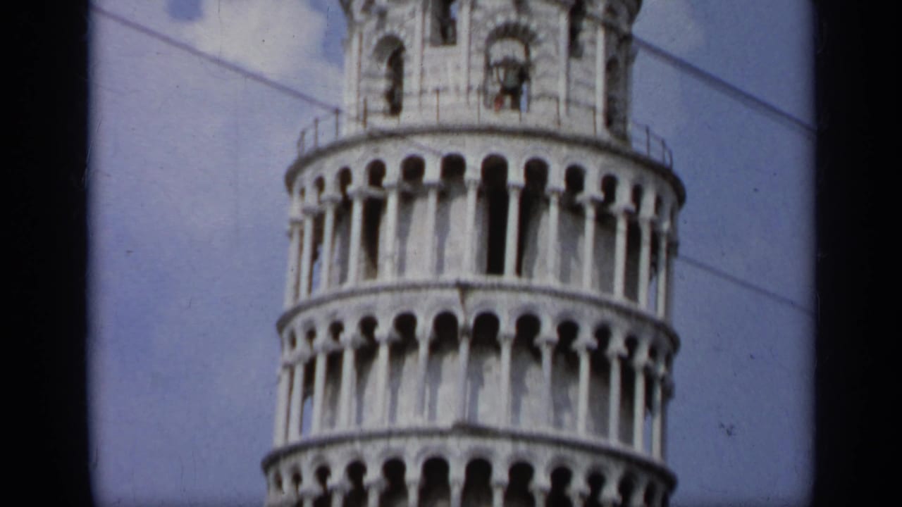 Upper section of the Leaning Tower of Pisa with arcades and part of the belfry.