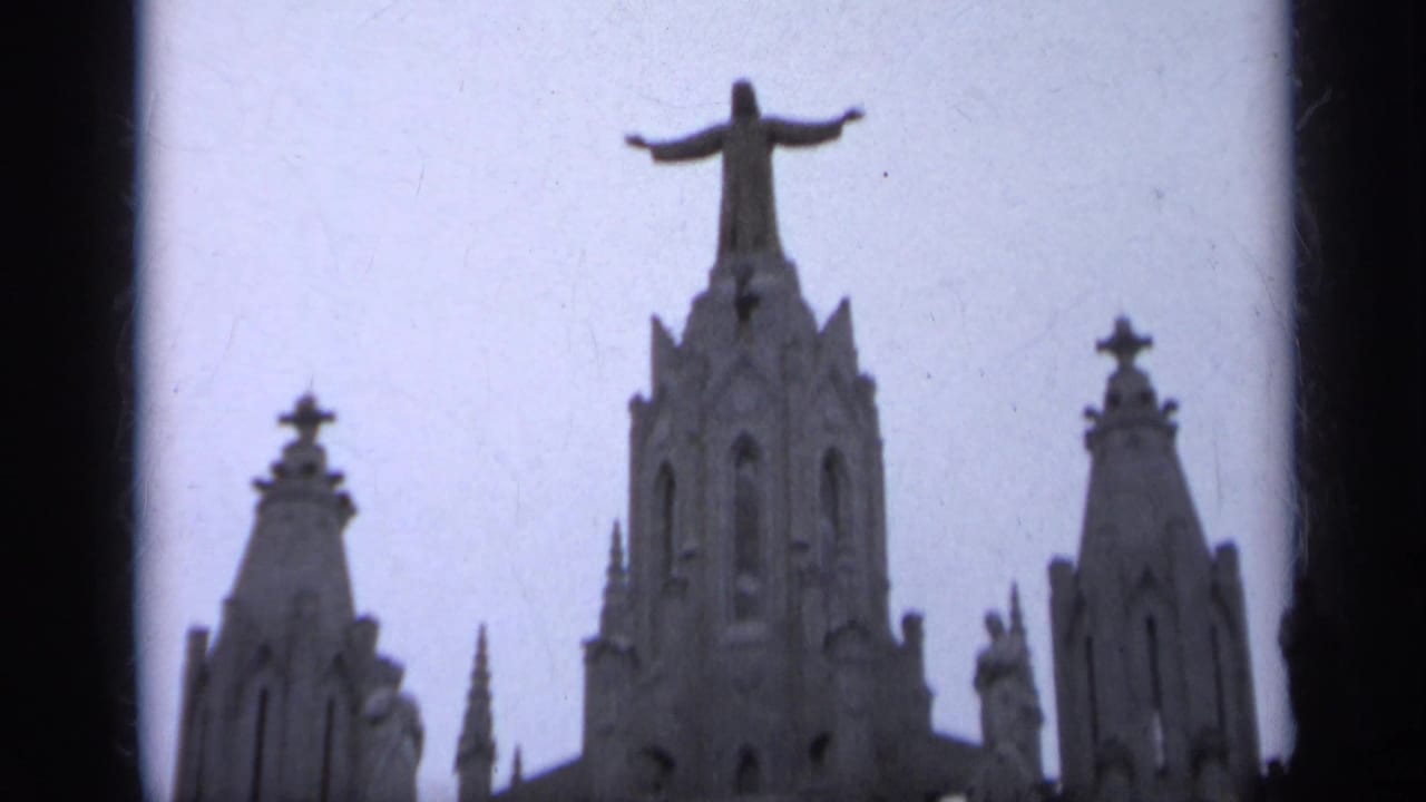 Gothic-style church spires with a Christ statue rising above the central tower.