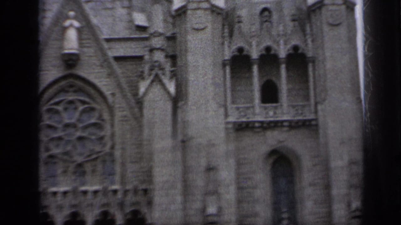 Close view of ornate Gothic-style stone church facade with rose window and pointed arches.