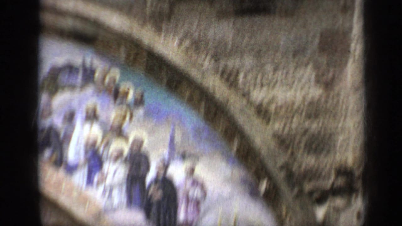 Soft handheld view of arched stone church details and a blurred religious mosaic.
