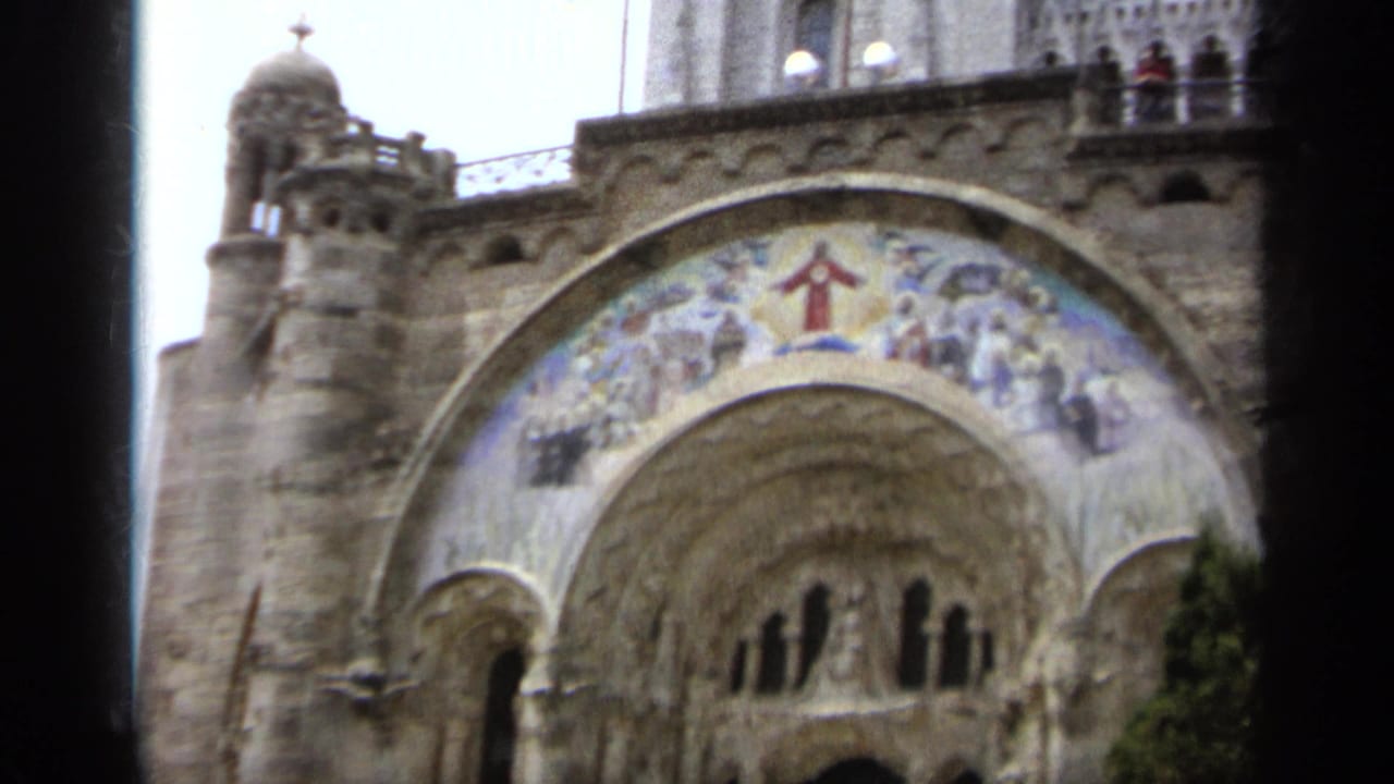 1962 Italy view of a historic stone church facade with a religious mosaic, carved arches, and upper architectural details.
