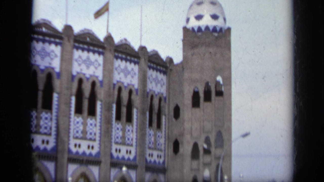 Ornate arena facade with blue-and-white tilework and arched windows.