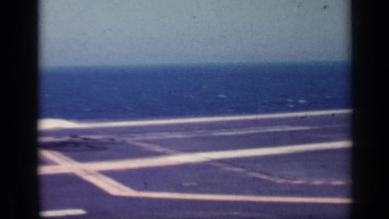 Empty marked carrier deck with the open sea beyond.