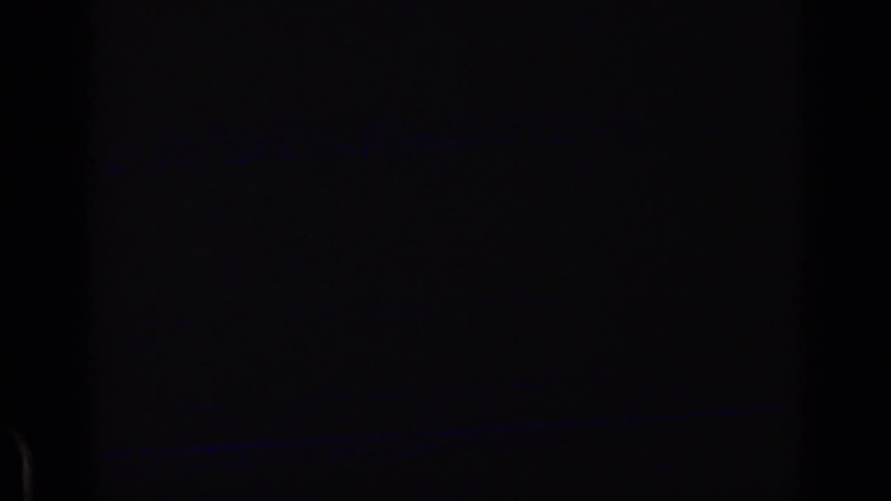 Mostly dark frame with faint blue line near the lower edge.