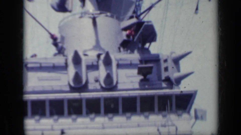 Close 8mm view of shipboard radar and antenna hardware above the bridge, consistent with the 1962 Italy metadata.