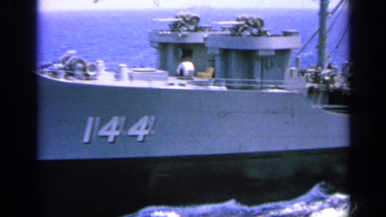 Side view of naval ship hull with number 144 and deck structures.