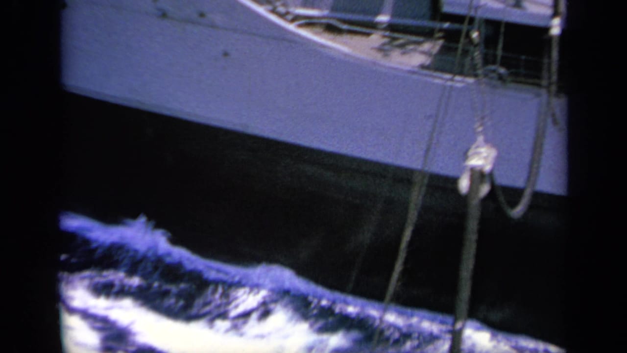 Final frame shows the ship's side, railings, deck equipment, and hanging lines above foamy water in the 1963 Greece-labeled reel.