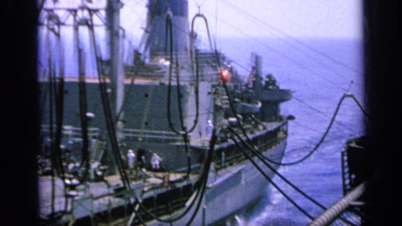 1963 Greece 8mm frame of a large ship's aft area with crew, superstructure, cables and open water beyond.