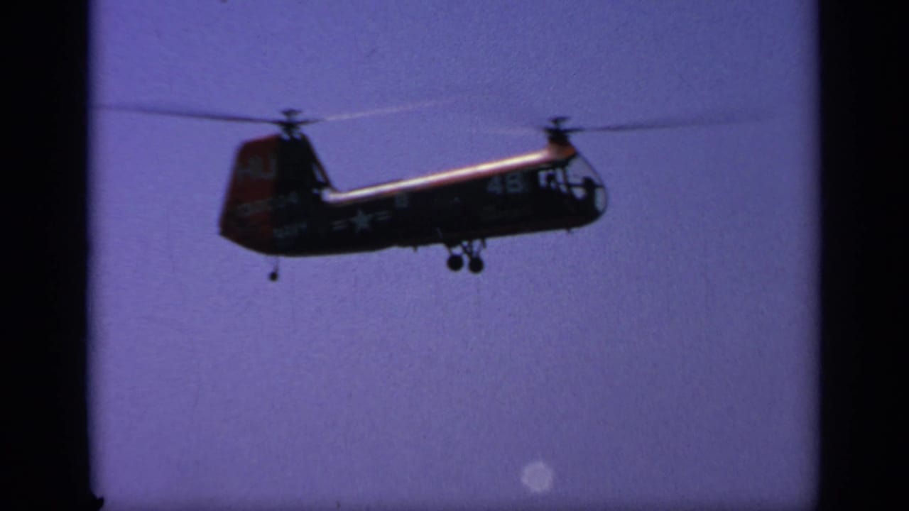 1963 Greece frame showing a military helicopter in profile, with visible numbers and insignia-like markings on its fuselage.