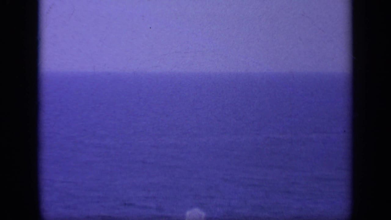 Blue ocean and hazy horizon seen through dark 8mm frame borders.