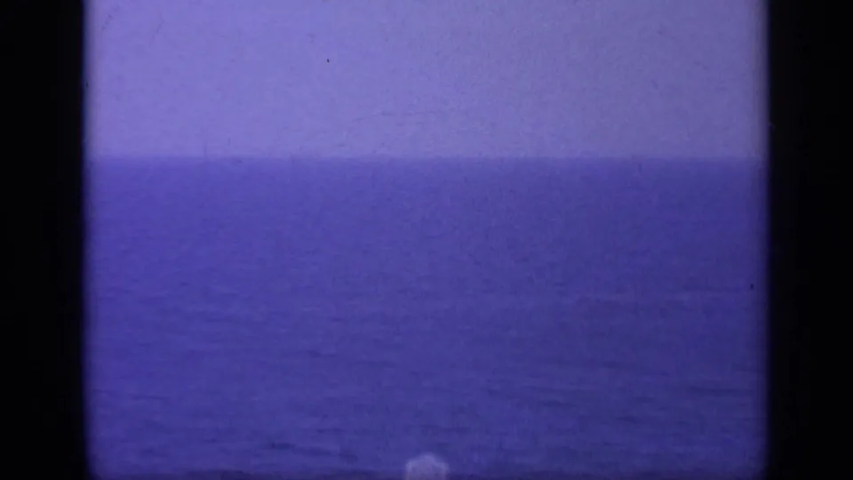 1963 Greece home-movie view of open blue water and a faint horizon from a shipboard vantage point.