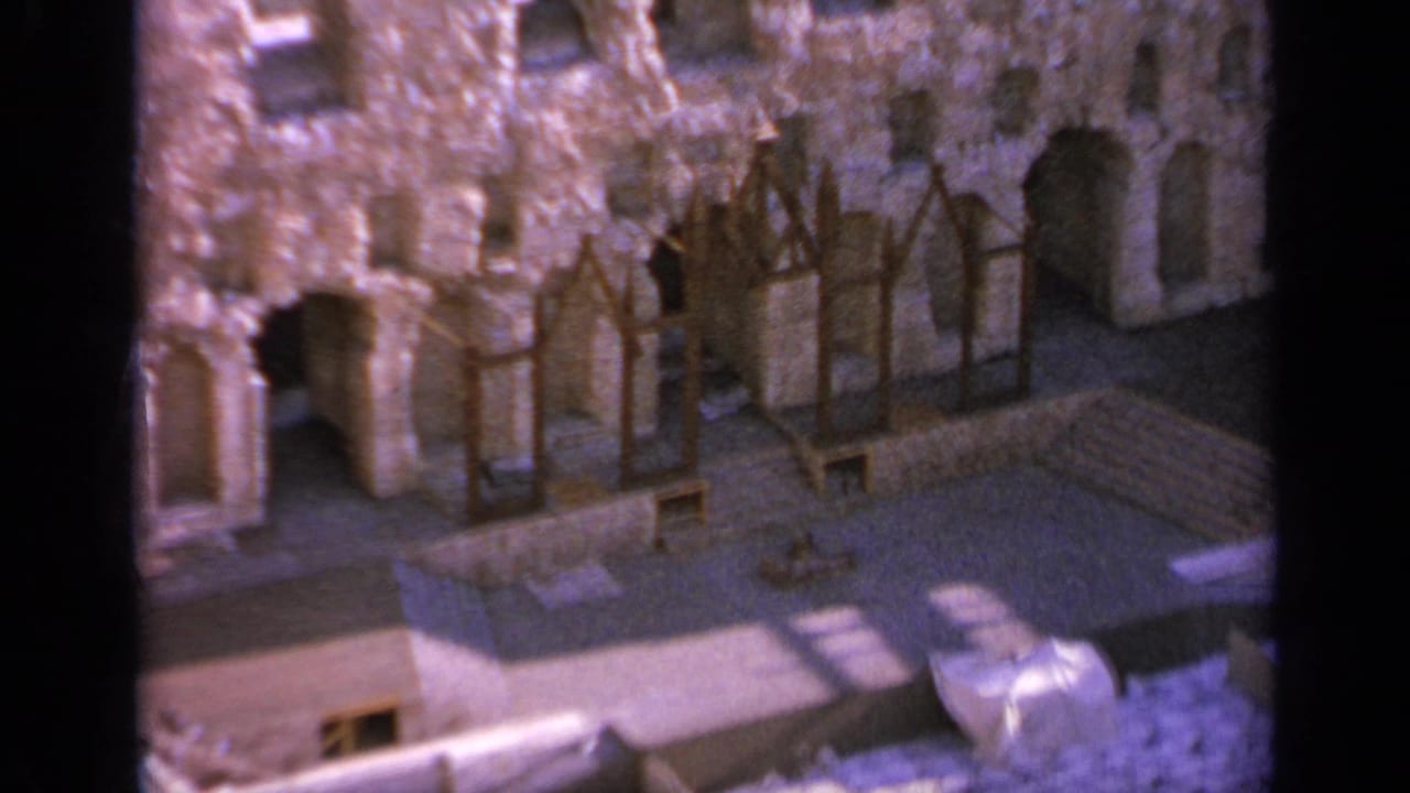 1963 8mm view in Greece of ancient stone ruins with arches, wooden bracing, and a sunlit stepped section.