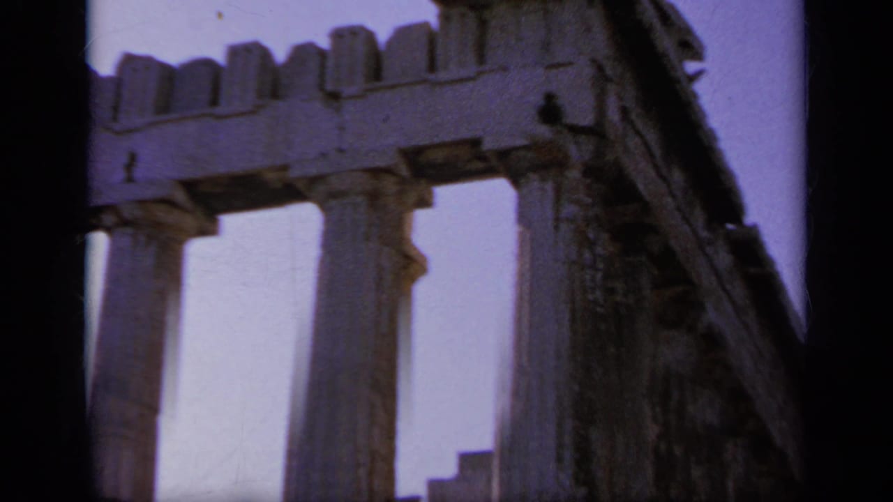 1963 Greece travel frame showing an angled temple corner with stone columns, entablature, broken masonry, and dark 8mm borders.