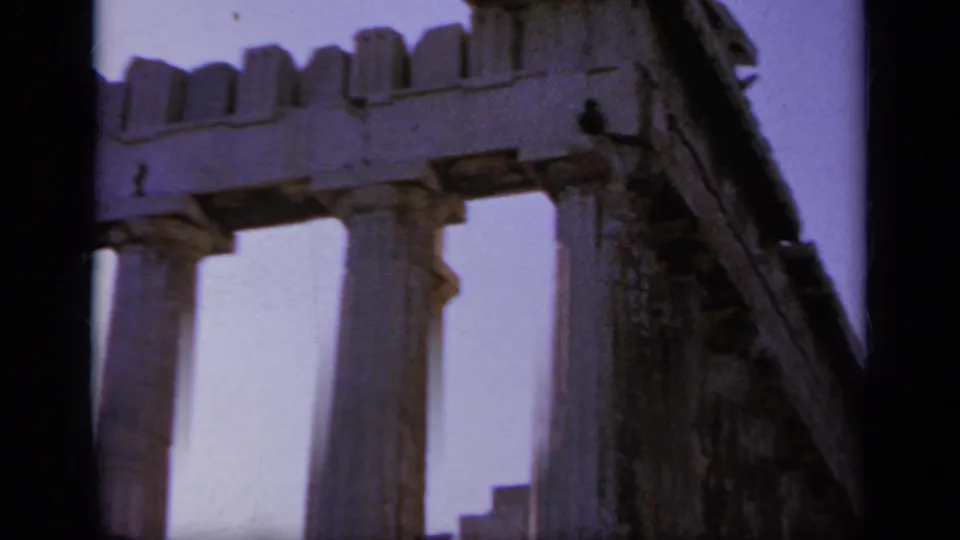 1963 Greece travel frame showing an angled temple corner with stone columns, entablature, broken masonry, and dark 8mm borders.