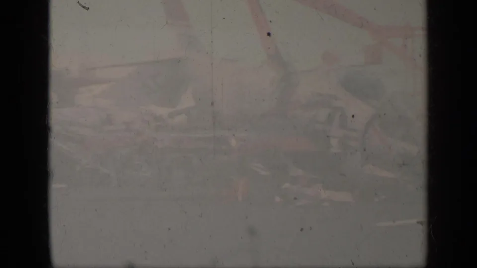 Heavily faded 1963 Greece 8mm frame with a barely visible aircraft scene obscured by exposure, dust, and vertical film borders.