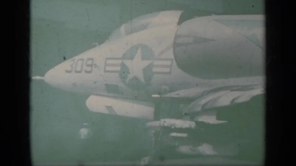 1963 Greece frame showing the nose of a U.S. Navy jet on a carrier deck, with star insignia and number 309 visible.
