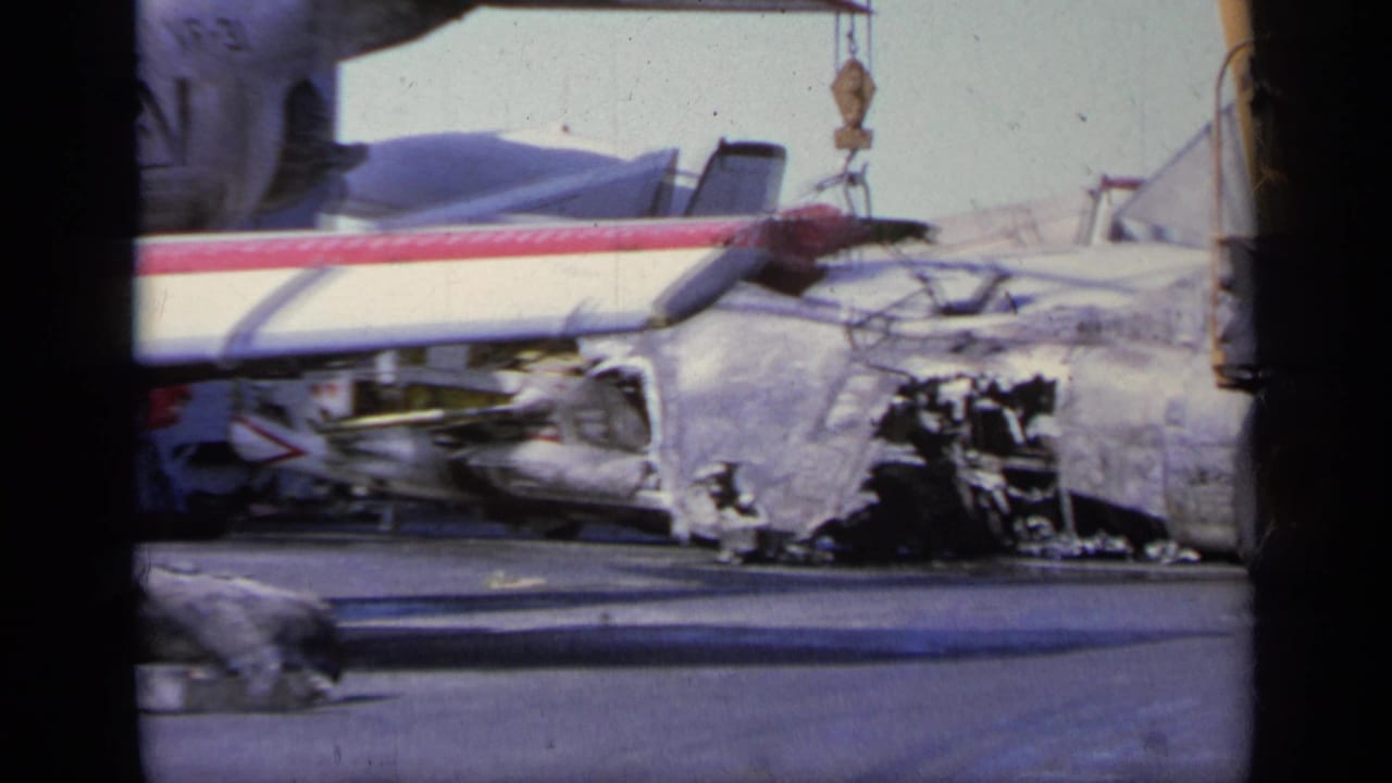 Close view of wrecked aircraft fuselage and wing damage on the tarmac.