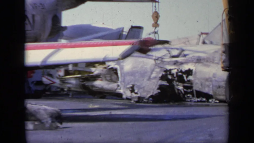 1963 Greece 8mm frame with a close view of torn aircraft fuselage, damaged wing structure, and scattered crash debris.