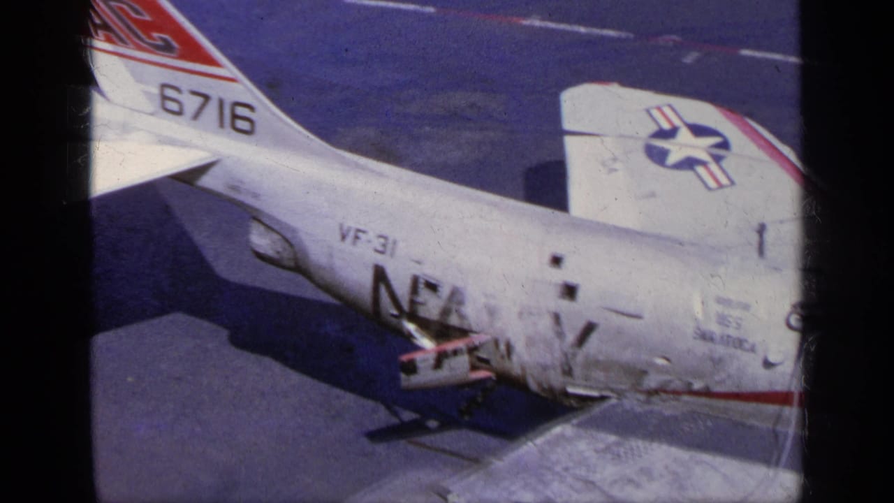 Close view of an F-104 fuselage and tail with open service area on the tarmac.