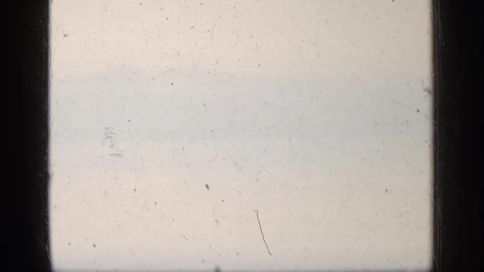 Overexposed 8mm frame from the 1963 Greece clip, with faint image detail and visible film wear.