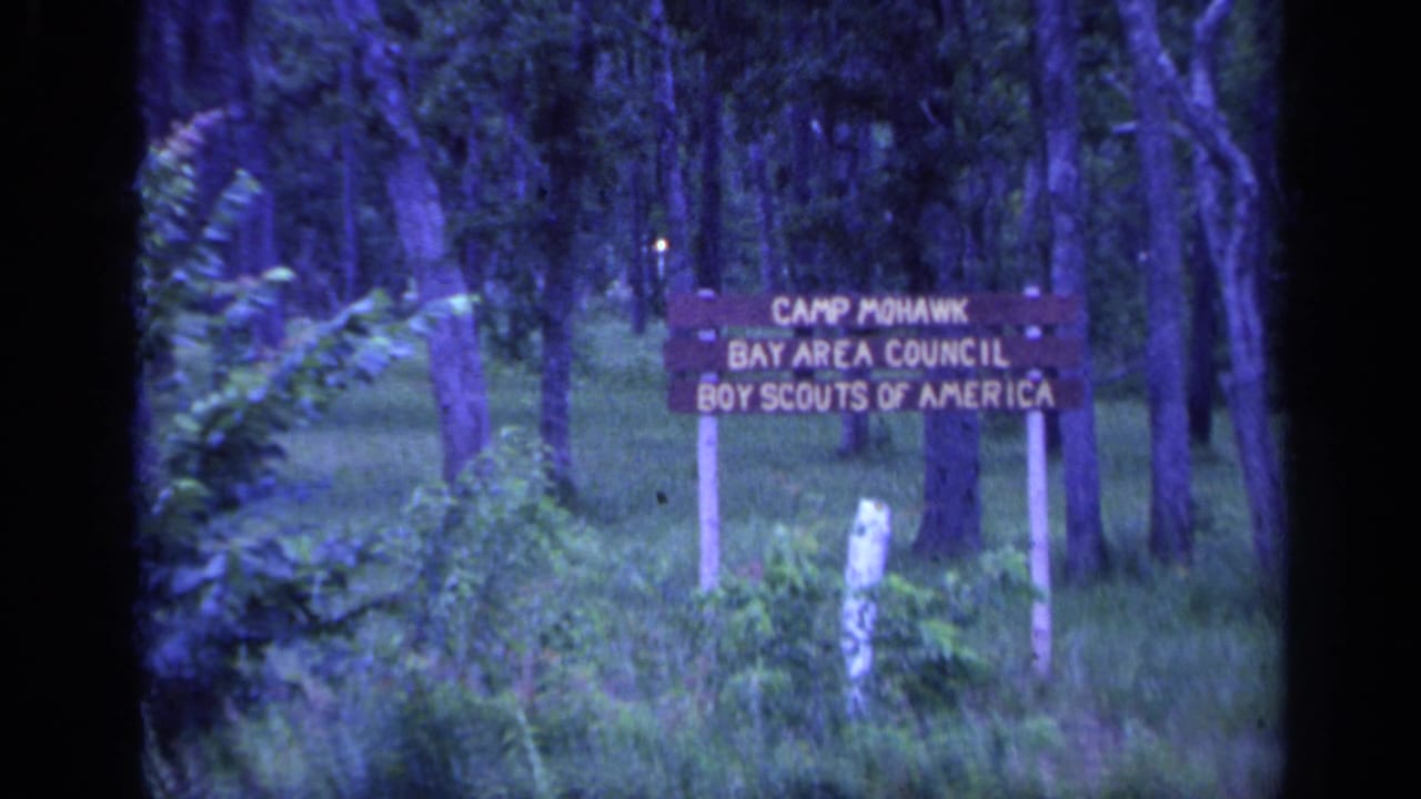 1968 Florida frame showing the Camp Mohawk Bay Area Council Boy Scouts of America sign among trees and grass.