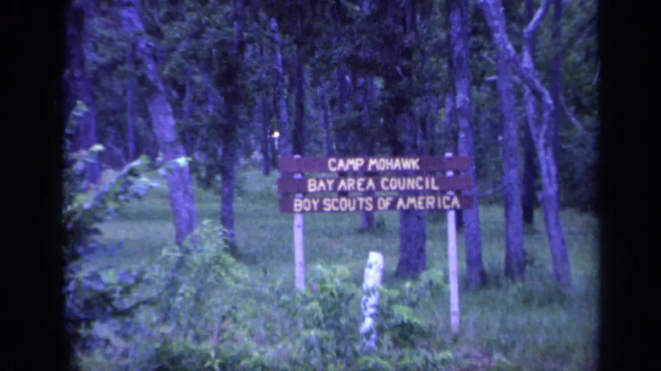 Final 1968 Florida frame of the Camp Mohawk Boy Scouts sign, with trees and grass surrounding the sign.