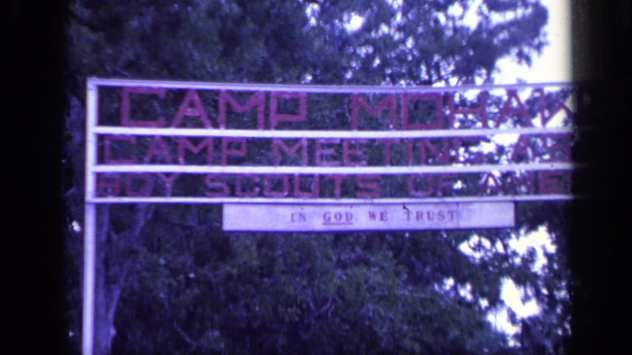 Camp Mohawk and Boy Scouts of America sign partly obscured by trees.