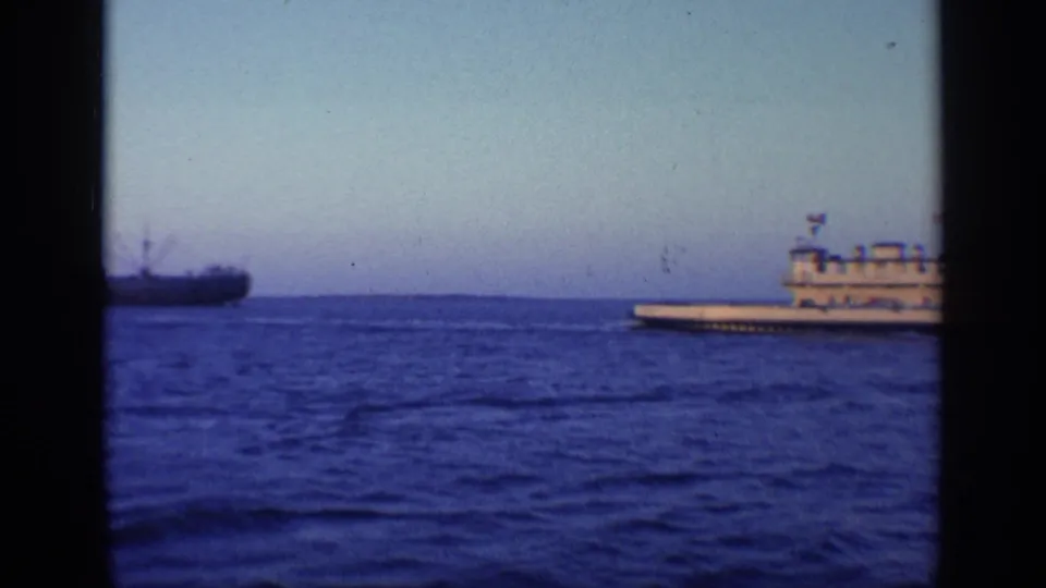 1968 Florida 8mm frame showing a large multi-deck vessel crossing open water, with another ship distant at left.