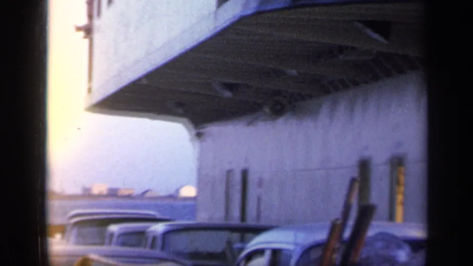 1968 Florida ferry deck view with classic cars lined along the side of the vessel in soft 8mm color.