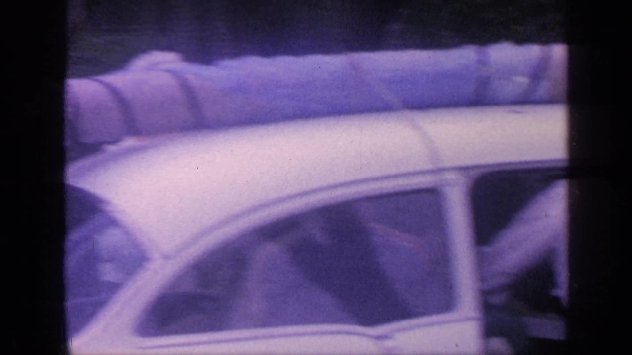 Close view of the roof and side windows of a white vintage car.