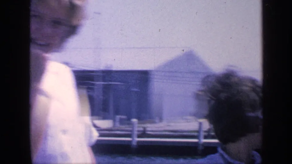 1968 Florida yacht cabin frame with a blurred adult moving past and another passenger seated near the window.