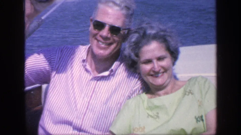 A closer 1968 Florida boat shot shows the older couple smiling toward the camera, framed by blue water and part of the vessel.