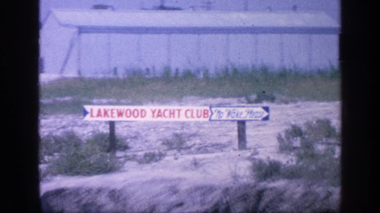 Lakewood Yacht Club sign and No Wake Please notice seen from a similar shoreline angle.