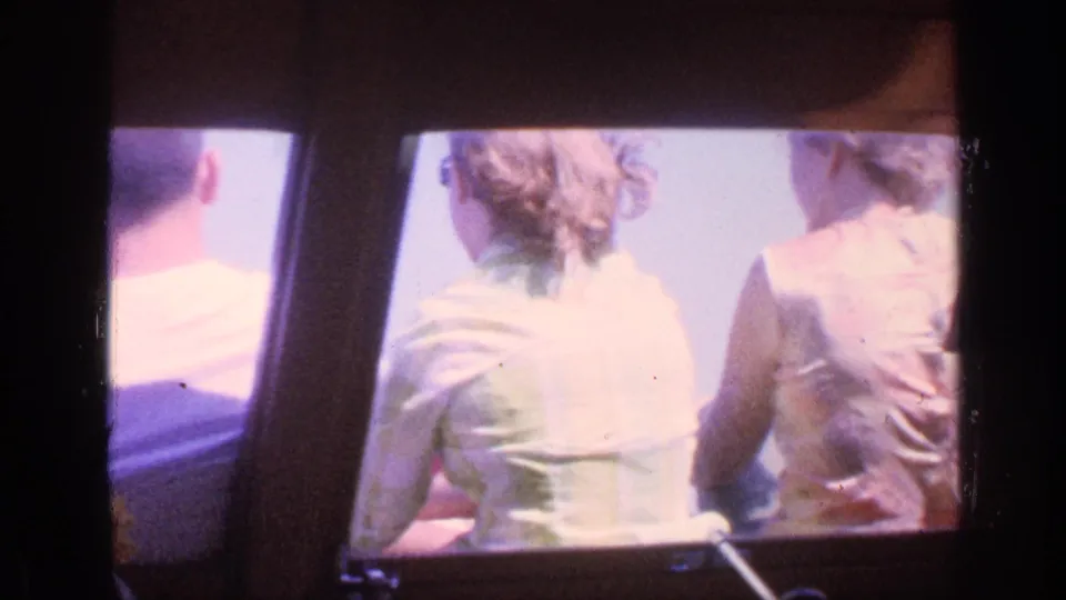 1968 Florida Super 8 frame showing young passengers from behind inside a boat, with bright exterior light beyond the seating area.