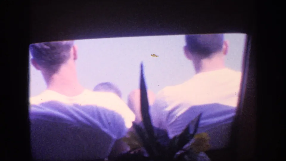 1968 Florida Super 8 frame from inside a boat, showing passengers seated ahead with a dark foreground silhouette and bright exterior light.