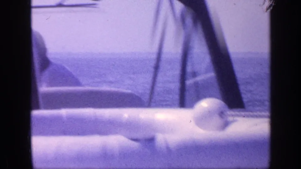 1968 Florida boating frame with white railings, deck hardware, open water and a partially visible passenger at the frame edge.