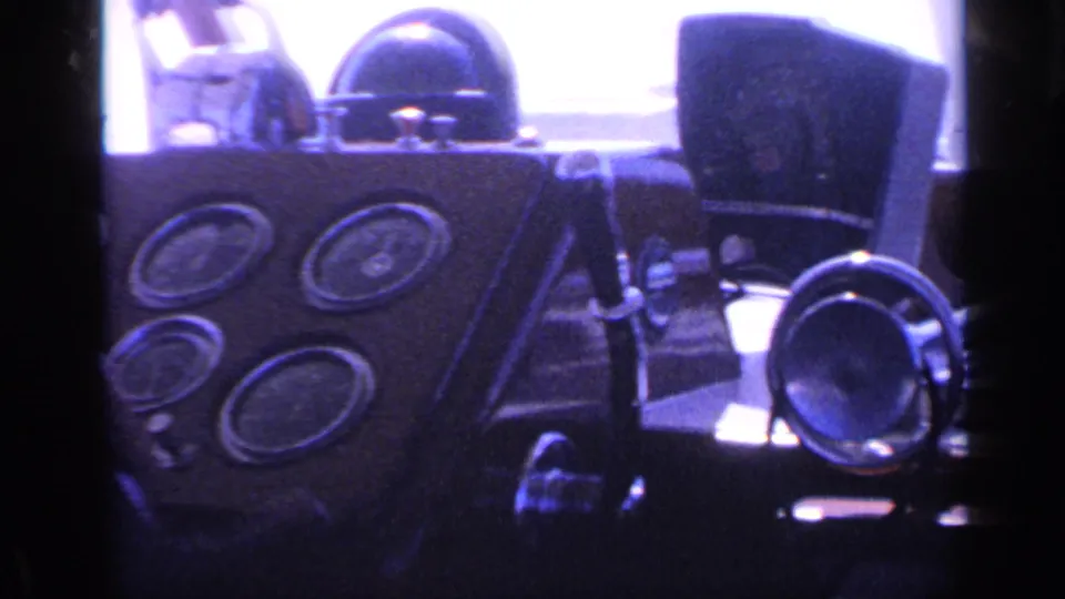 1968 Florida boat cockpit frame with clustered analog gauges, steering wheel, horn, and chair back in blue-purple 8mm color.