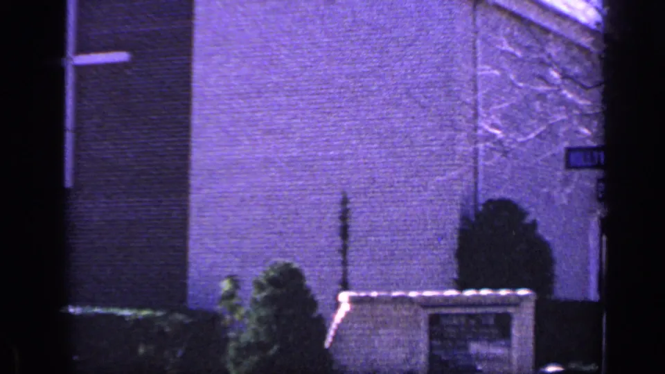 Church corner in Florida with a stone sign, shrubs, brick wall, and a visible Hollywood Ave street sign at the edge of frame.
