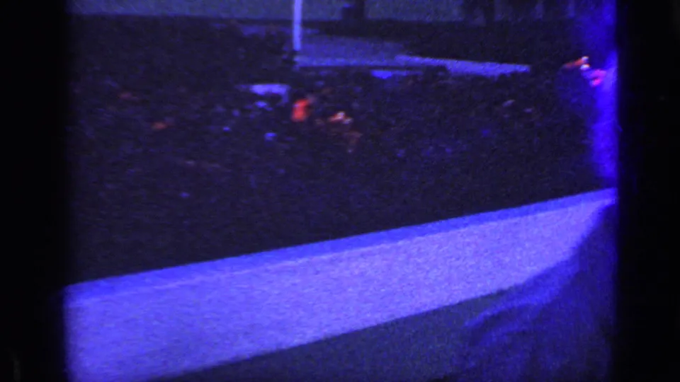 The final frame shows the fountain edge, dark blue water, red flower reflections, and a partial figure at the right edge of the frame.