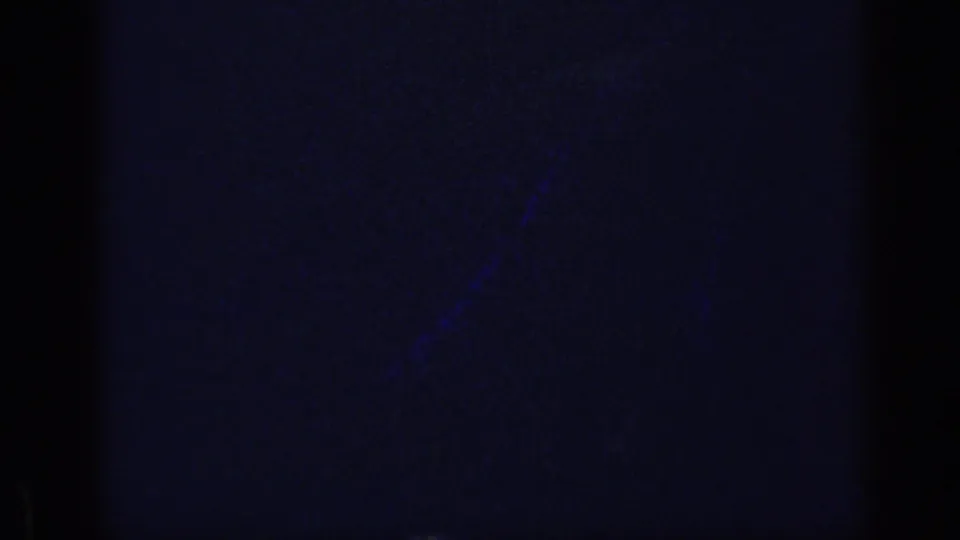 Dark ending frame from the 1969 home-movie clip, with blue color cast, grain and faint edge shadows from the film scan.