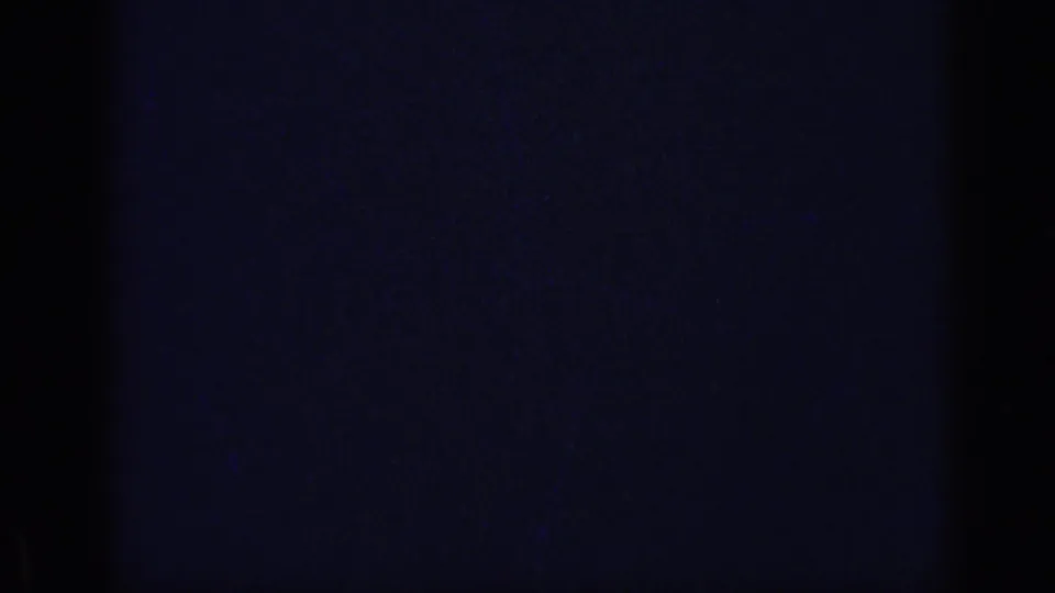 Mostly dark 8mm frame with faint grain and color cast at the end of the 1969 California home-movie clip.