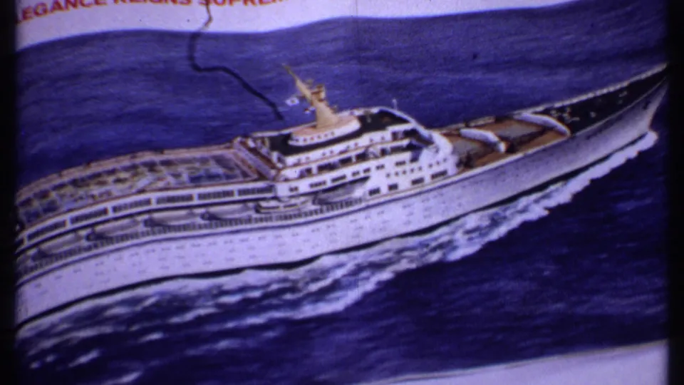 1969 Bahamas travel footage shows a close filmed view of a printed cruise ship illustration with deck rows, ocean artwork, and aged color shift.
