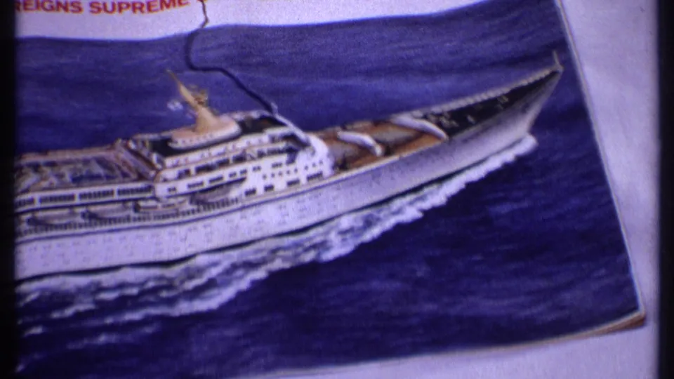 The final 1969 Bahamas frame shows the bow end of a printed cruise ship illustration, blue sea artwork, white page edge, and dark film border.