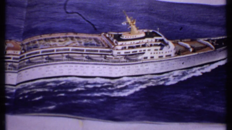 1969 Bahamas frame showing the printed cruise ship photo broadside, with decks, dark blue water, white wake, and a visible fold or crease above.