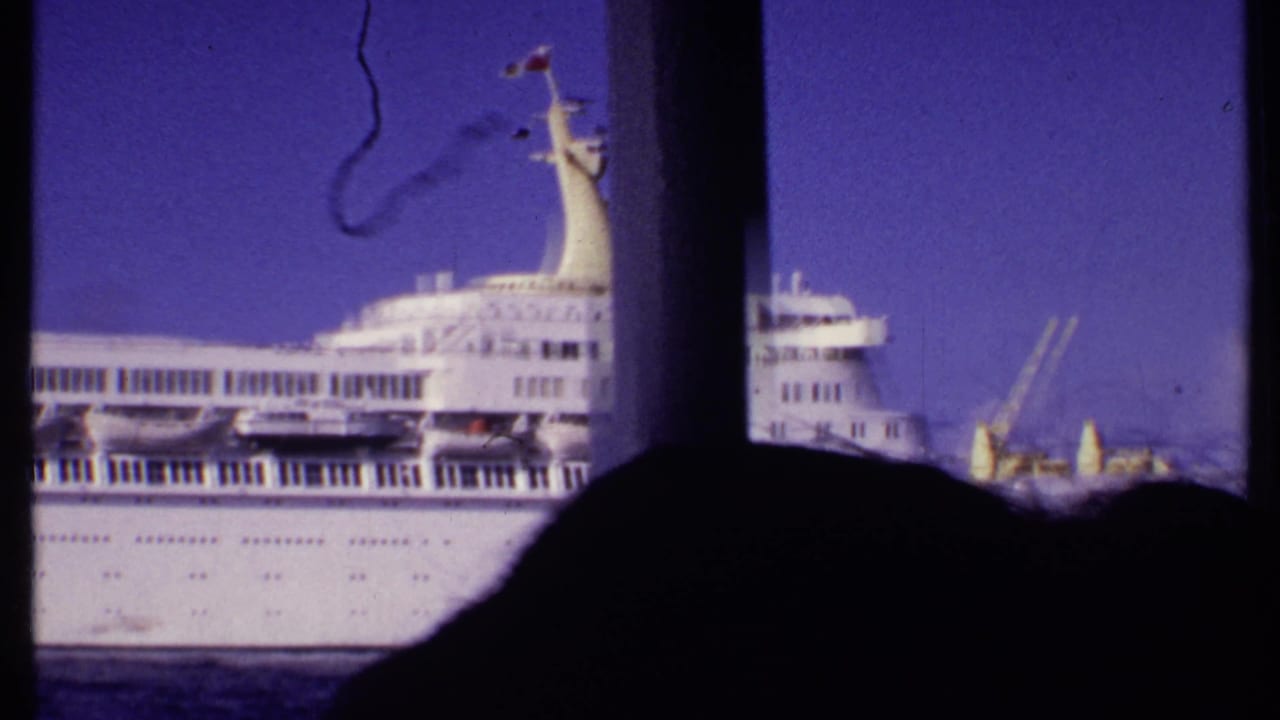1969 Bahamas 8mm frame showing the rear portion of the white cruise ship, partially obscured by dark foreground shapes.
