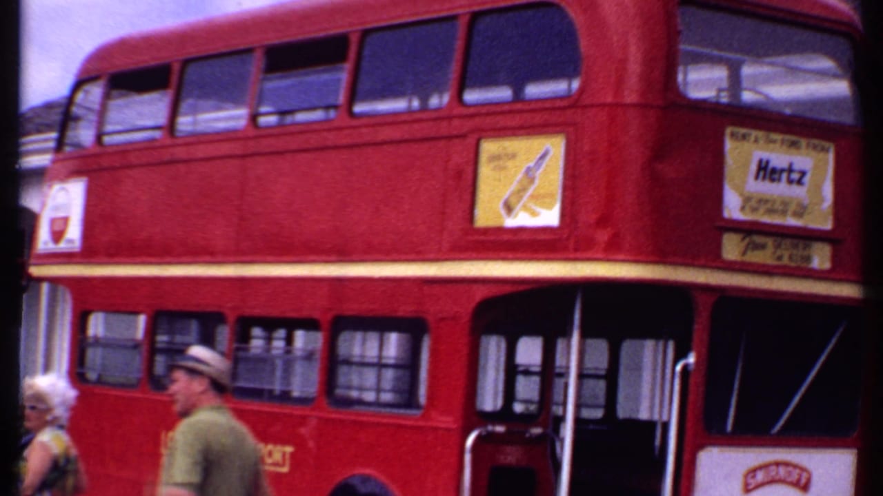 Front half of a red double-decker bus with open doors and advertising panels.