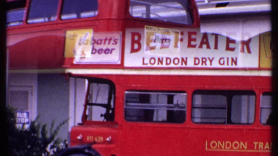 1969 Bahamas 8mm frame of the red bus side with a large Beefeater London Dry Gin advertisement and London Transport lettering.