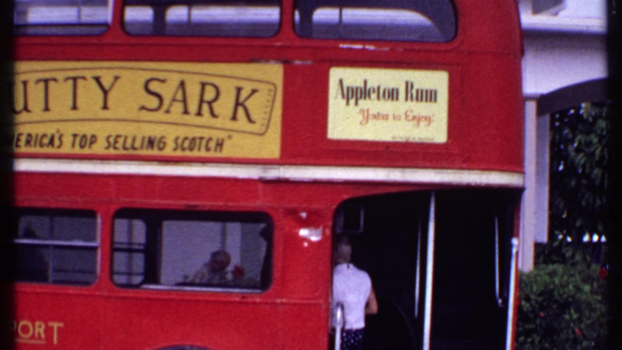 Red double-decker bus with Cutty Sark and Appleton Rum advertisements and a person boarding.