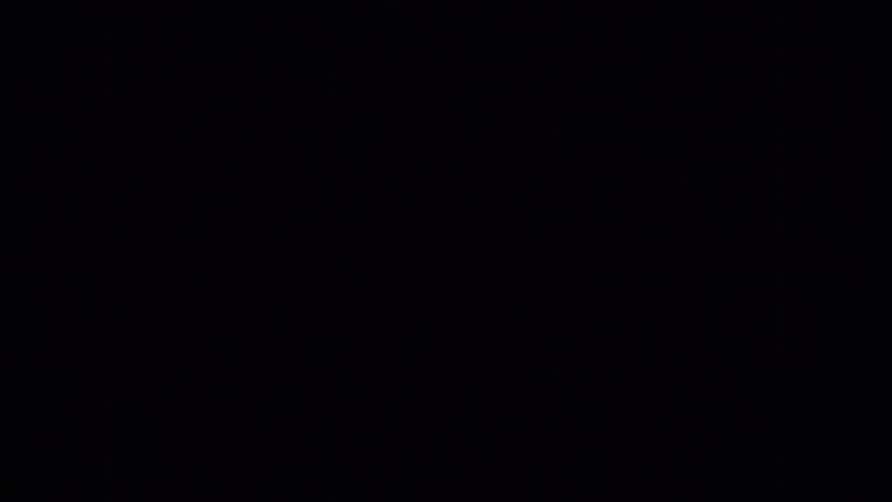 Mostly dark 8mm frame from the Bahamas vacation clip, with only faint film texture and edge darkness visible.